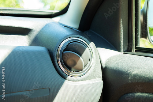 An air vent on a car dashboard in a bright sunny day