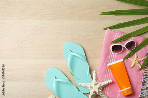 Flat lay composition with beach objects on wooden background. Space for text
