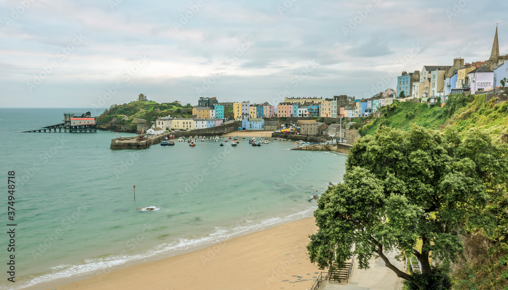 A view from North Cliff of the multi-coloured Georgian town of Tenby, the harbour and Goscar Rock at sunrise in Autumn
