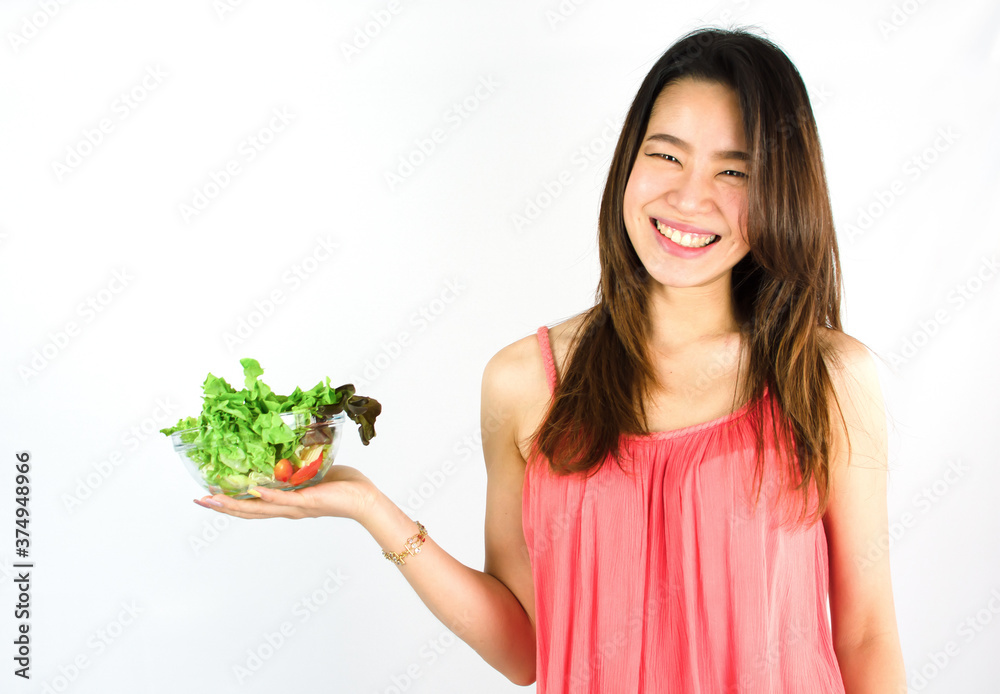 Asian healthy woman presenting vegetable and standing on white background Asian healthy woman presenting vegetable and standing on white background