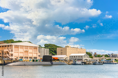 yokosuka, japan - july 19 2020: Japanese submarine Takashio ss-571 berthed in front of  japan maritime self-defense force Diving Group Command and the dry docks buildings of the Yokosuka naval port. photo