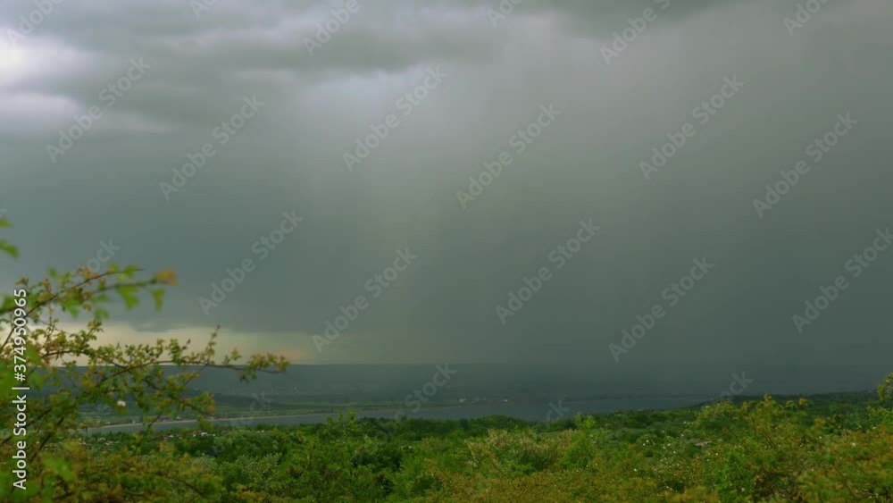 Clouds and sunbeams over the hills and lake in summer time lapse Clouds and sunbeams over the hills and lake in summer time lapse