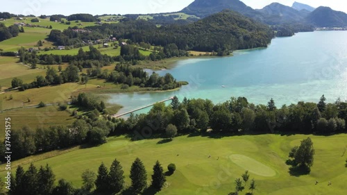  flight over the golf course and birch lake against the backdrop of mountains