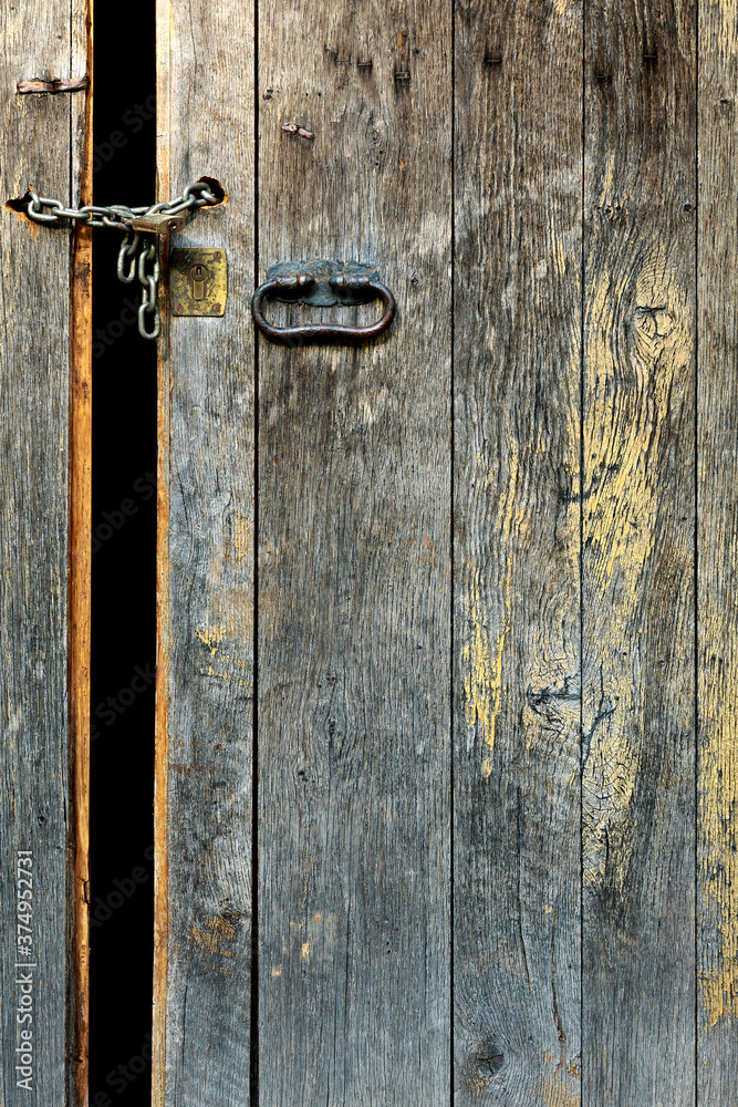 Old medieval door with chain and padlock