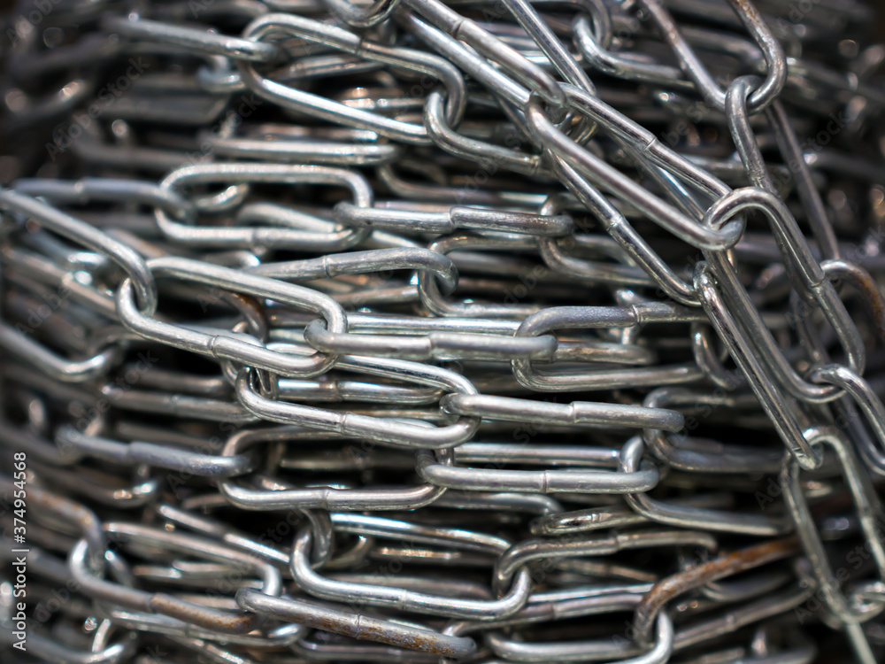 Links of a metal chain coiled into a small roll