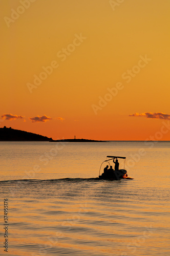 Fishermen on the adriatic sea at orange sunset in Croatia © Jan