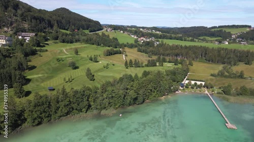  flight over a birch lake with a view of the mountains and the golf course