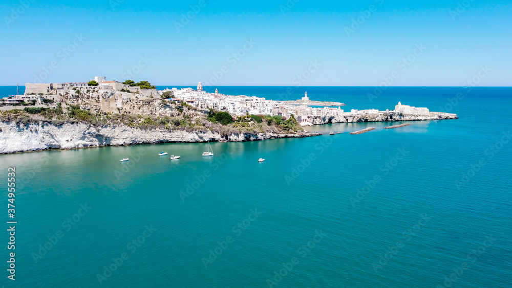Aerial view of Vieste on the Gargano Peninsula in Italy - Narrow peninsula with white houses built on a hilltop over the Adriatic Sea Aerial view of Vieste on the Gargano Peninsula in Italy - Narrow peninsula with white houses built on a hilltop over the Adriatic Sea
