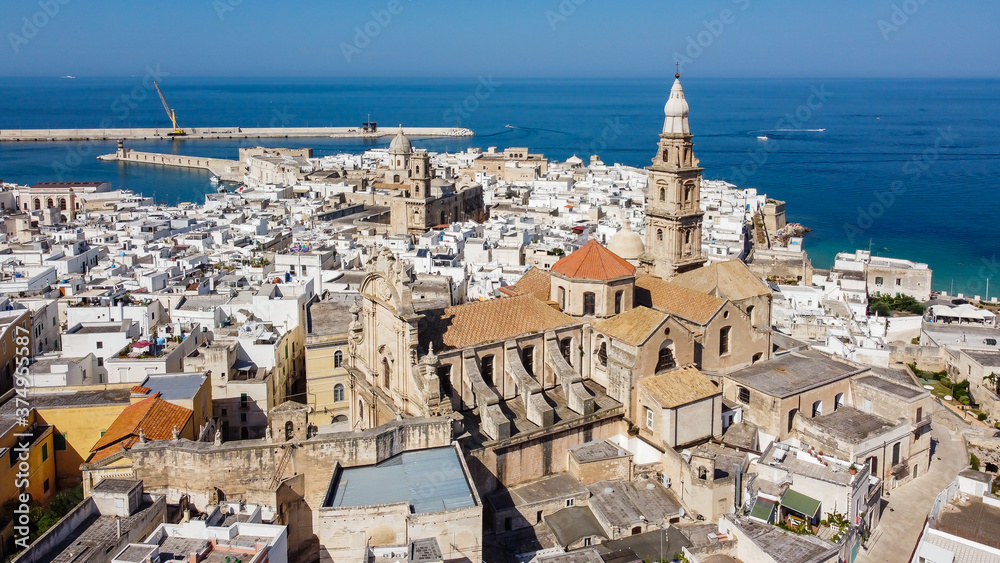 Aerial view of Monopoli in Apulia, south of Italy - Monopoli Cathedral aka Basilica of the Madonna della Madia from above, in front of the Adriatic Sea - Side view