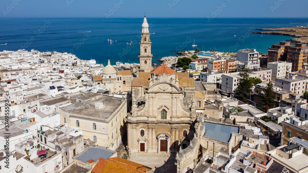 Aerial view of Monopoli in Apulia, south of Italy - Monopoli Cathedral aka Basilica of the Madonna della Madia from above, in front of the Adriatic Sea - Front view