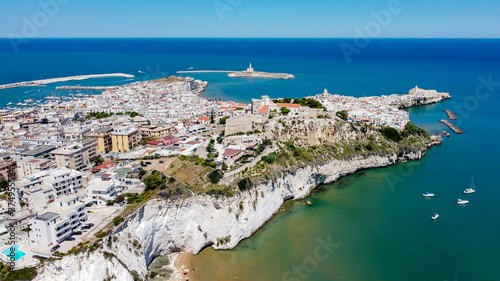 Aerial view of Vieste on the Gargano Peninsula in Italy - Narrow peninsula with white houses built on a hilltop with a lighthouse on an island in the Adriatic Sea