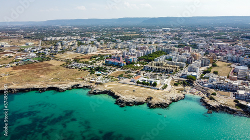 Aerial view of Monopoli in Apulia, south of Italy - Irregular coast with sandstone cliffs and blue waters along the Adriatic Sea © Alexandre ROSA