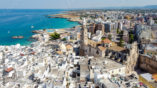 Aerial view of Monopoli in Apulia, south of Italy - Monopoli Cathedral aka Basilica of the Madonna della Madia from above, in front of the Adriatic Sea