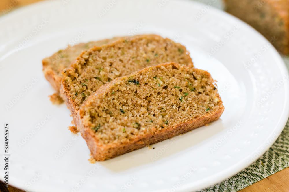 Slices of delicious and sweet Zucchini Bread on a White Plate Slices of delicious and sweet Zucchini Bread on a White Plate