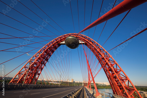 Photography Arched red-coloured cable-stayed bridge
