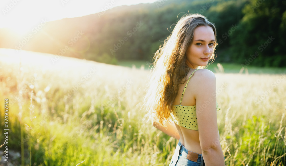 Portrait of young teenager girl outdoors in nature at sunset. Portrait of young teenager girl outdoors in nature at sunset.