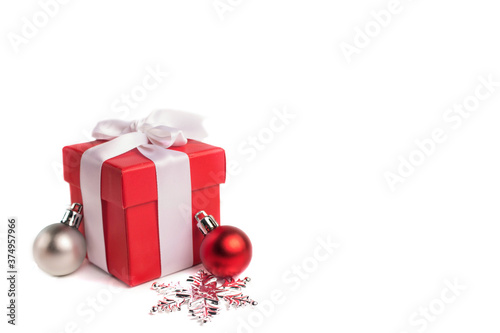 red gift box with christmas balls and snowflake