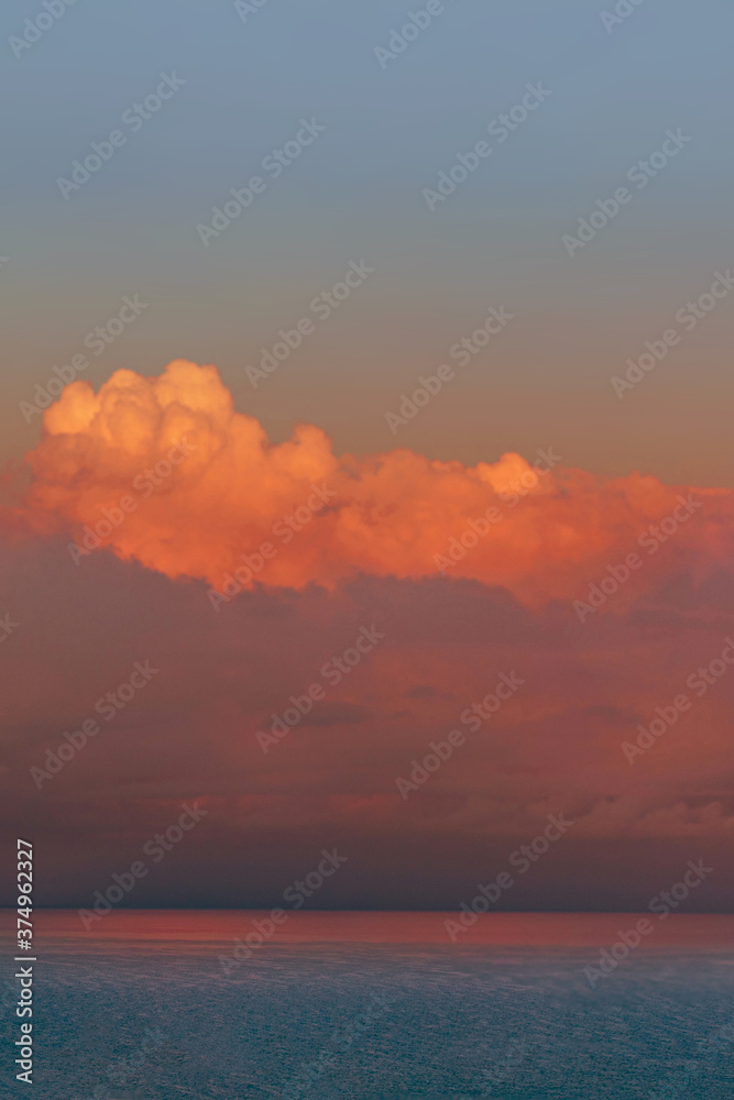 Sunset seascape with dramatic sky and colorful clouds. Fantastic view of the dark overcast sky and sea