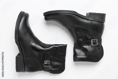 Stylish black female boots on white background, top view