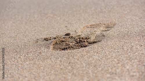 Footprint on the sand. Macro Photography with selectable focus.