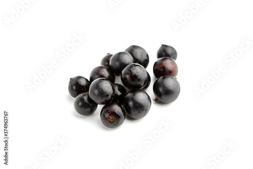 Ripe black currant berries isolated on white background
