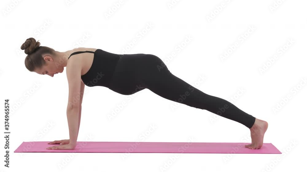 Side view of fit Caucasian pregnant woman standing in plank position. Pregnancy workout. Isolated on white background.