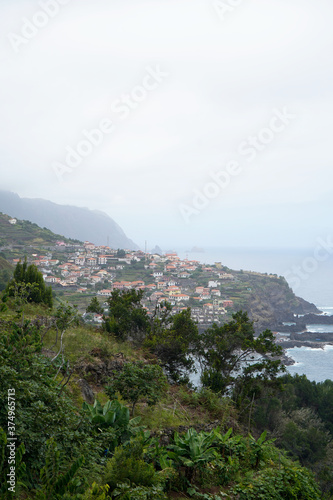 The view of the cliffs and Seixal village in Madeira Island, overcast day.