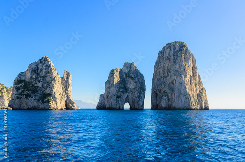 Capri Island view of the famous cliffs Faraglioni.