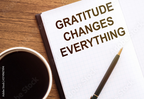 Gratitude changes everything - motivation writing on a notebook on table