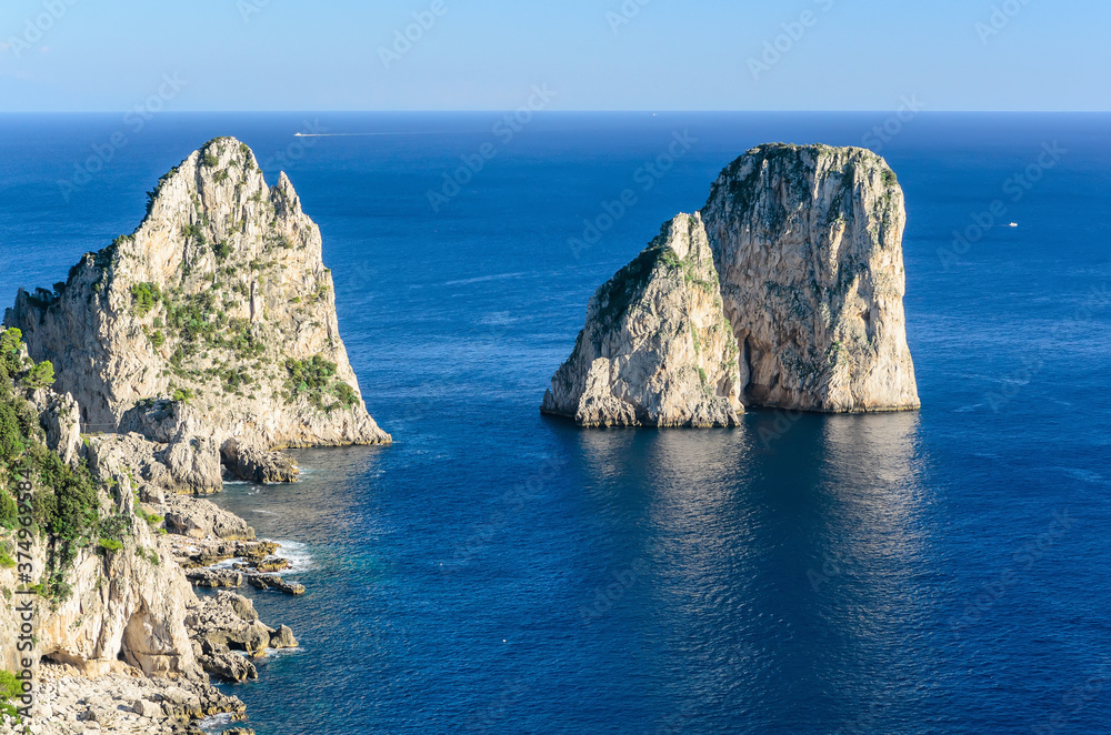 Capri Island view of the famous cliffs Faraglioni.