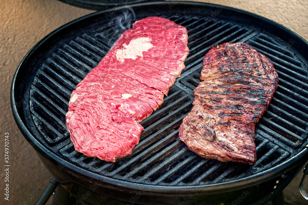 Barbecue wagyu bavette beef steak preparing as closeup on a kettle