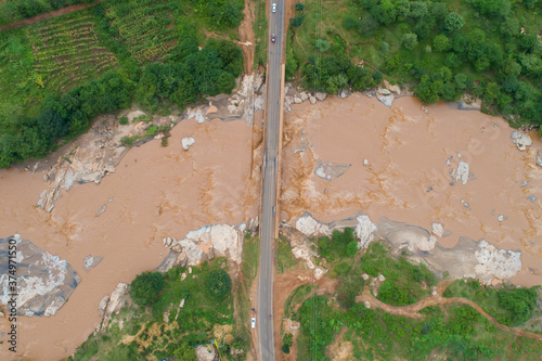 Aerial view of Kaiti River flowing past the Machakos-Wote Road in Makueni, Kenya. It drains into the Athi River which changes name to Galana then Sabaki before it drains into the Indian Ocean. photo