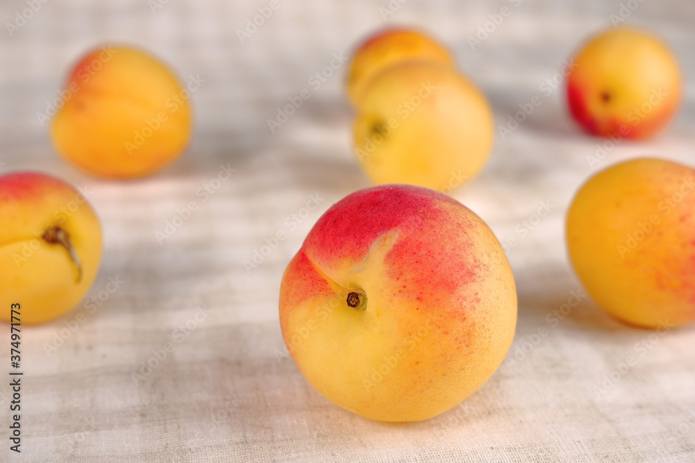 Juicy peaches on a checkered cotton background. Juicy peaches on a checkered cotton background.