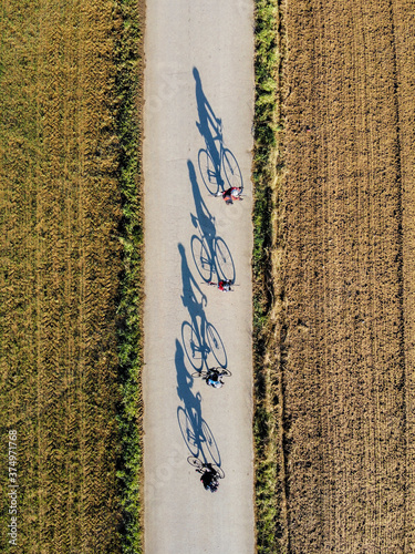 Aerial view of cyclists on sunny day in Sant Miquel de Cruilles, Spain photo