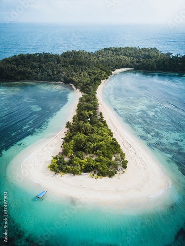Aerial view of Cabgan Islet surrounded by turquoise water in Barobo, Surigao del Sur, Philippines photo