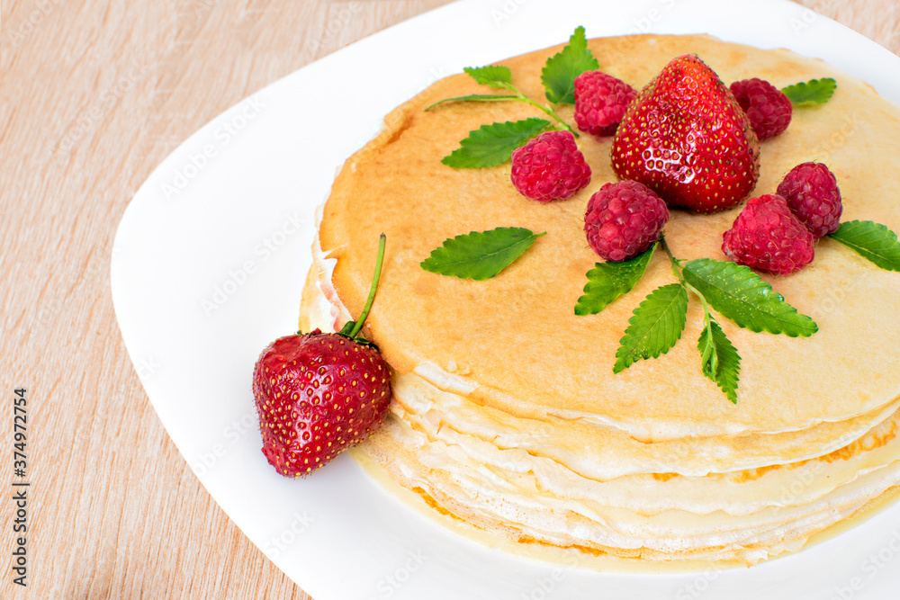 Pancakes with strawberries and raspberries. Pancakes with raspberries and strawberries on a plate. Pancakes with raspberries and strawberries on a plate and a wooden board. Pancakes with strawberries and raspberries. Pancakes with raspberries and strawberries on a plate. Pancakes with raspberries and strawberries on a plate and a wooden board.
