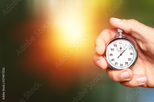 Silver classic stopwatch in human hand