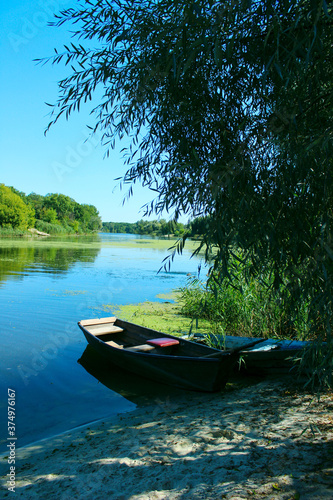 Two old wooden boats on the river bank. Nature, travel, landscapes concept. 