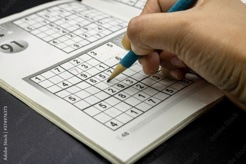Sudoku game in magazine on a black background, games to exercise the brain Sudoku game in magazine on a black background, games to exercise the brain