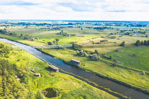 Obraz na płótnie Aerial view over historical german dam combined with a railroad embankment built in 1938 for defense purposes. Drezdenko / Poland. w salonie