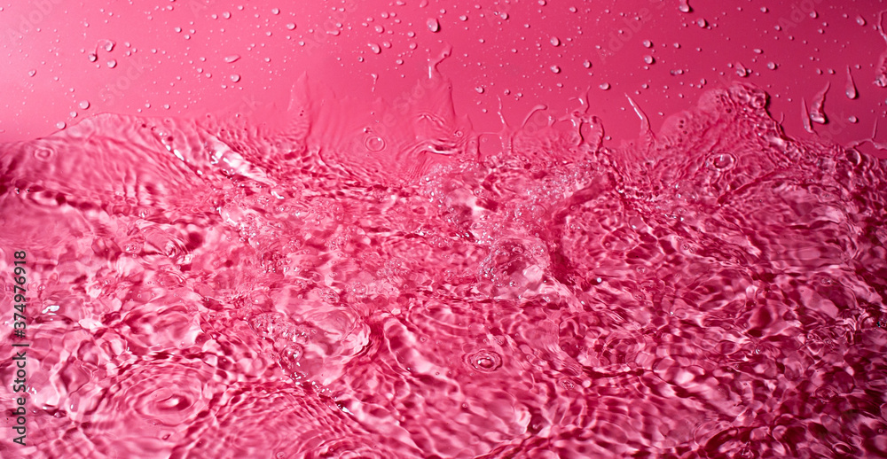 splash of water on a red background. Abstract wallpaper splash of water on a red background. Abstract wallpaper