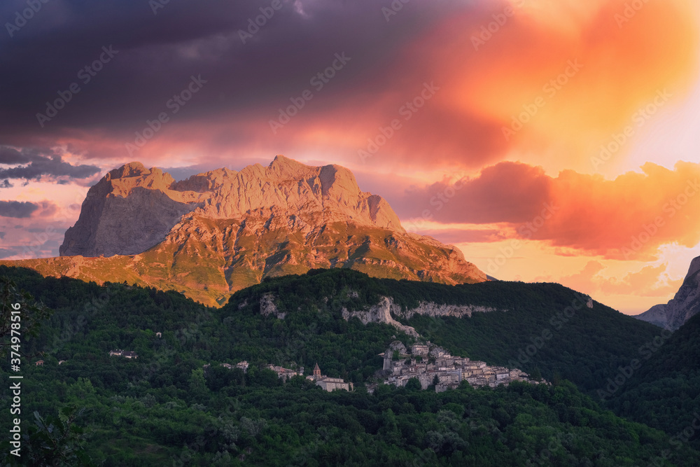 small horn of the mountain area of the gran sasso d'italia with a view of the town of pietracamela at sunset