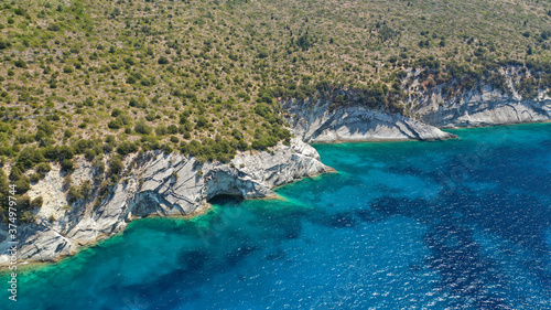Aerial photo taken by drone of Caribbean tropical exotic steep cliff island bay with turquoise clear sea sandy beaches and rare limestone trees