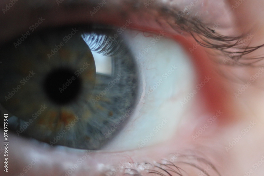 Naklejka premium blue eye closeup with orange flecks in iris 