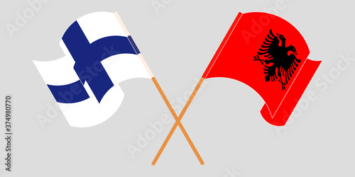 Crossed and waving flags of Albania and Finland