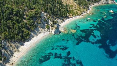 Aerial photo taken by drone of Caribbean tropical exotic steep cliff island bay with turquoise clear sea sandy beaches and rare limestone trees