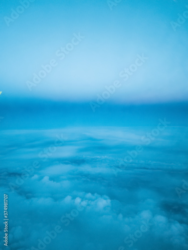 clouds. top view from the window of an airplane flying in the clouds. clear blue sky under high clouds located