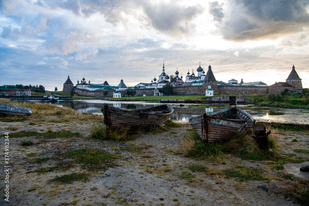 landscape of the island against the background of old wooden boats lying on the shore
