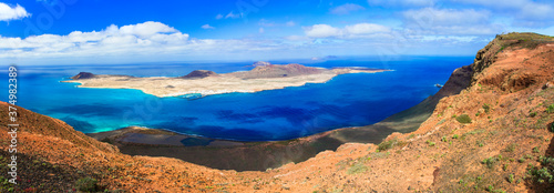 Scenery of volcanic Lanzarote - panoramic view from Mirador del Rio for island Graciosa. Canary islands