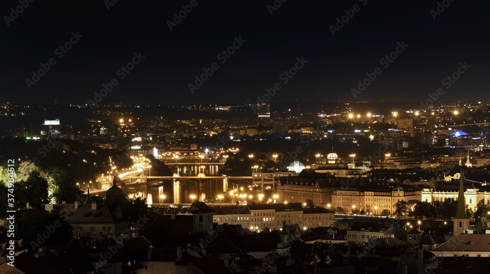 Night panoramic photo of the city with the river and beautiful reflections on the surface